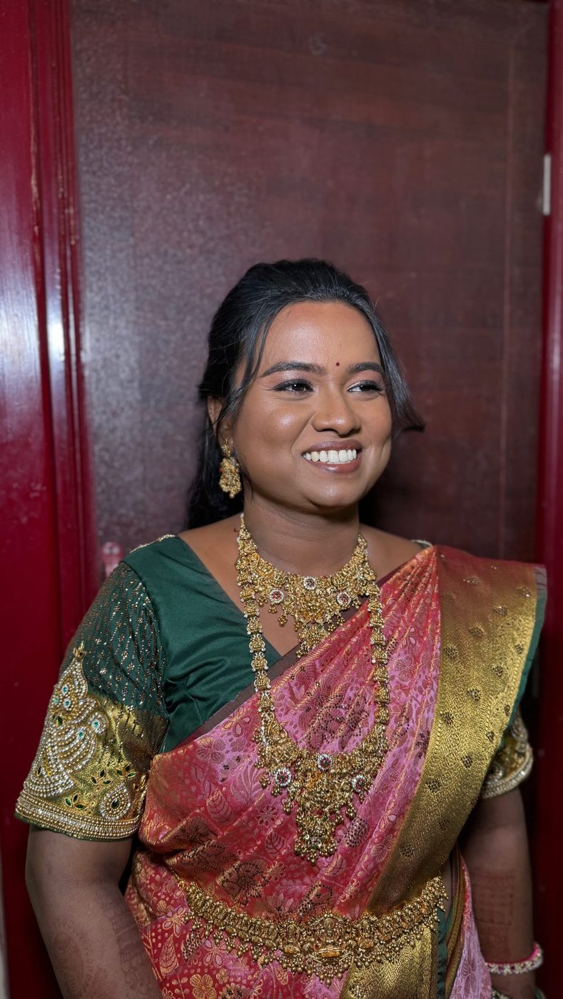 Bride in pink and emerald silk saree